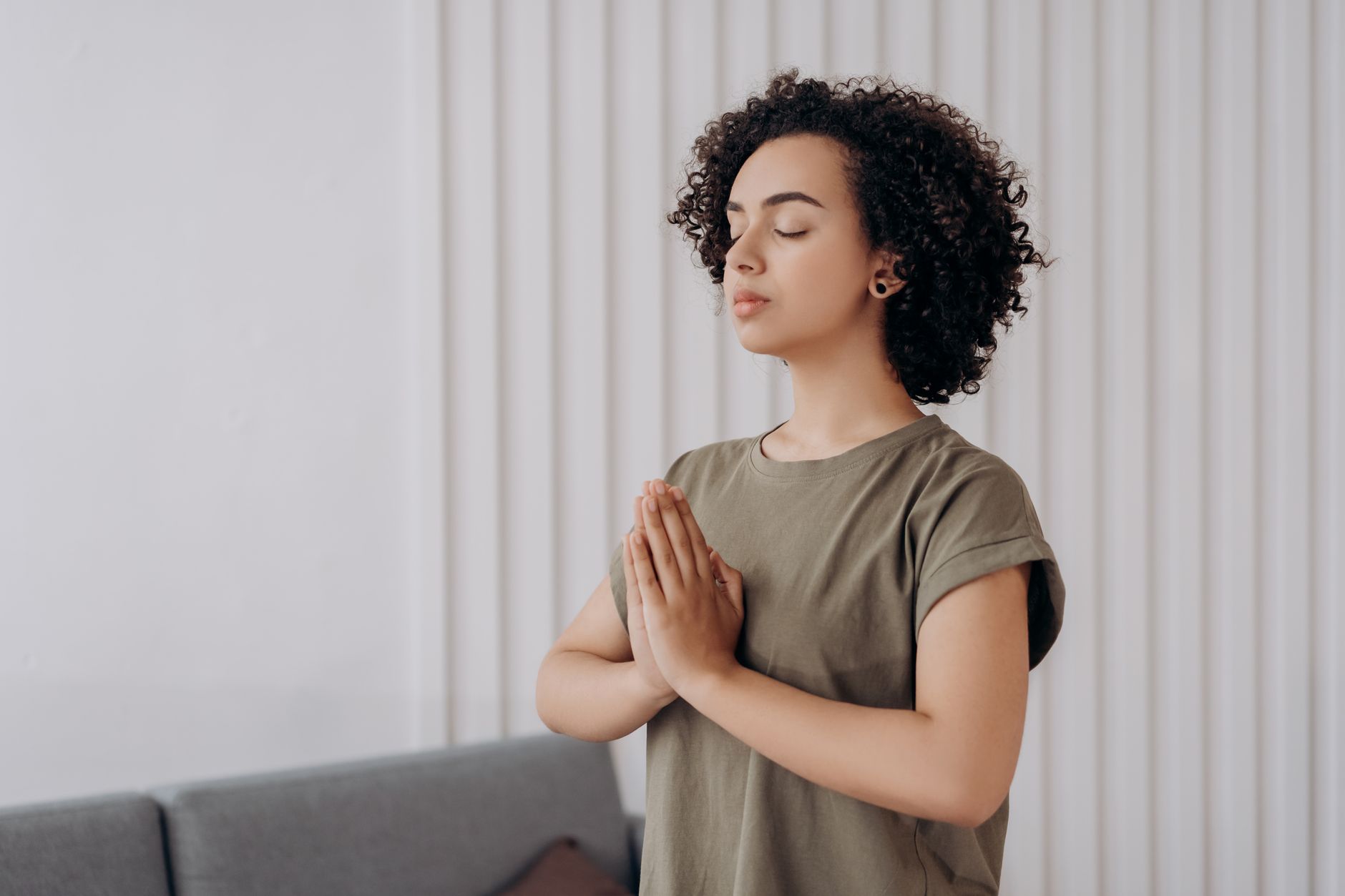 Person meditating calmly at home