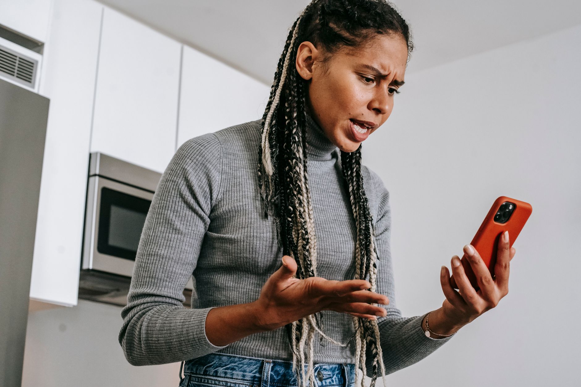 Anxious person checking their phone worriedly