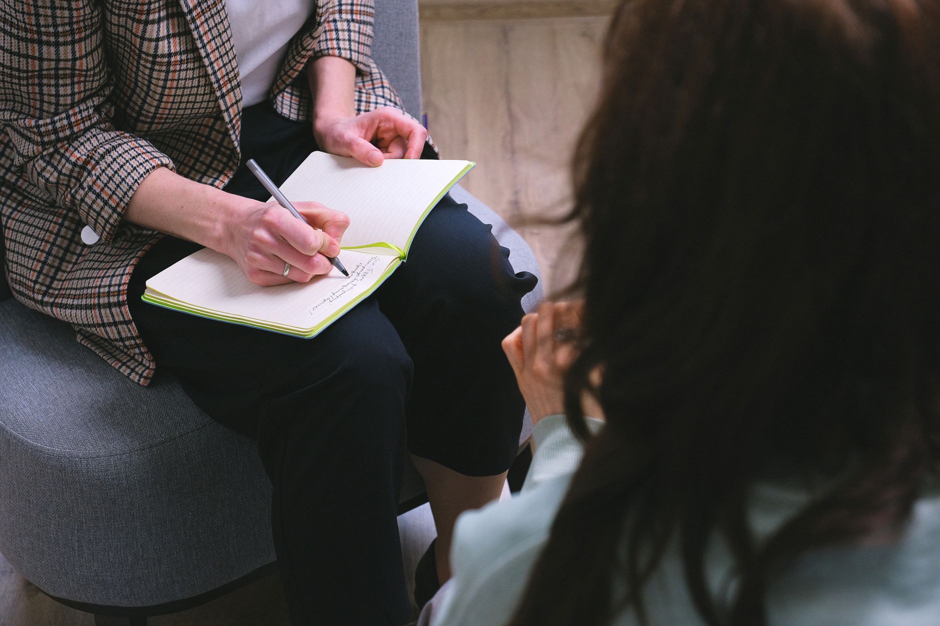 Therapist taking notes during a CBT session