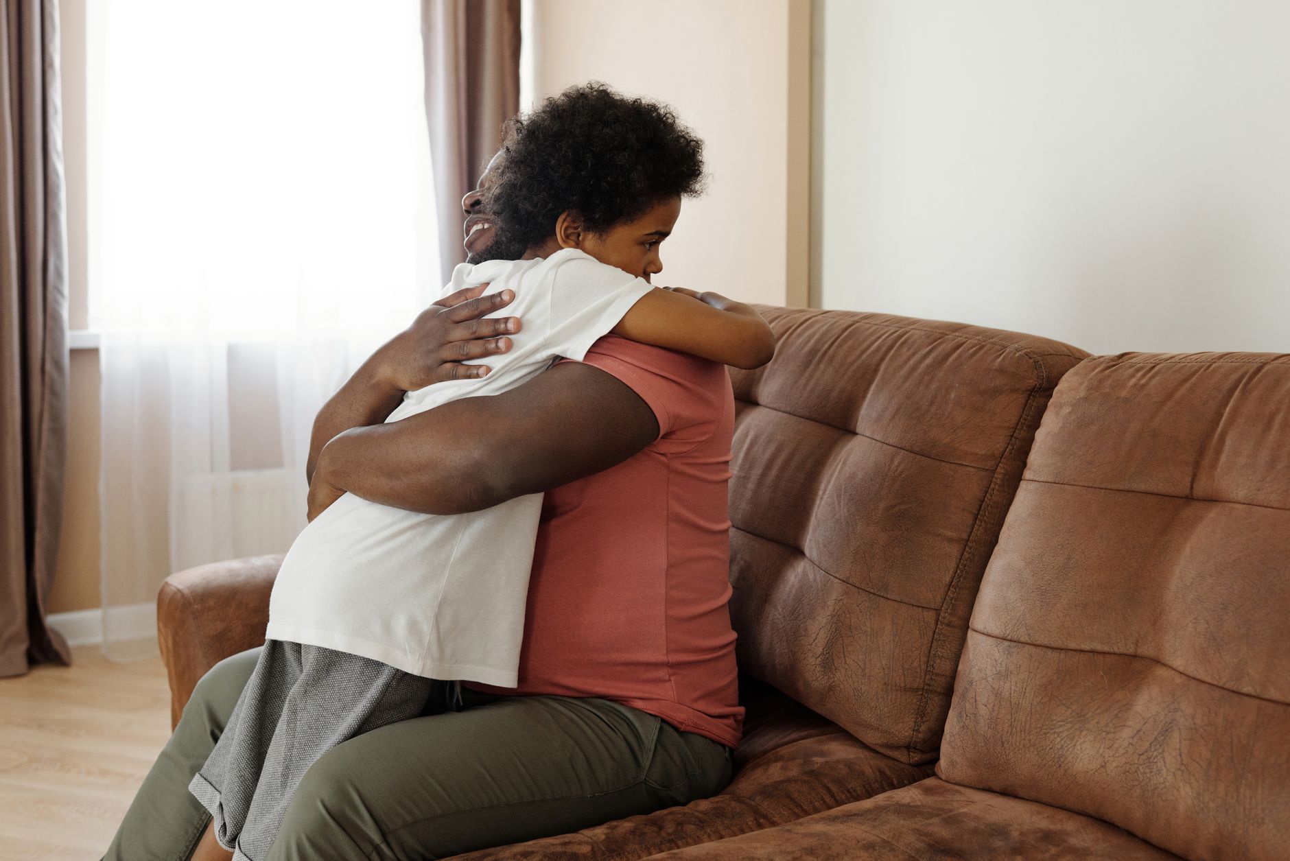 Parent and child sharing a warm, supportive hug