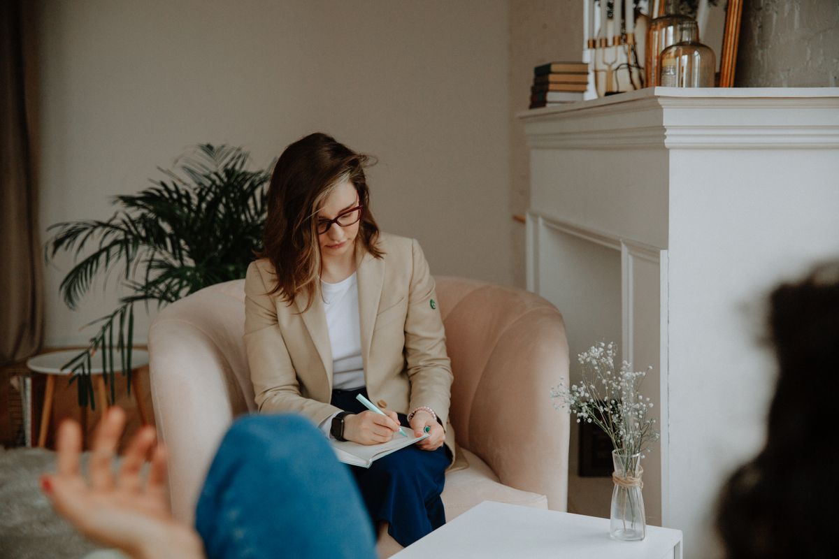 Registered psychotherapist taking notes during a session in Milton