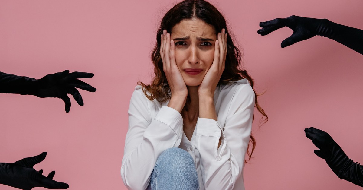 Woman sitting on the floor looking anxious and overwhelmed