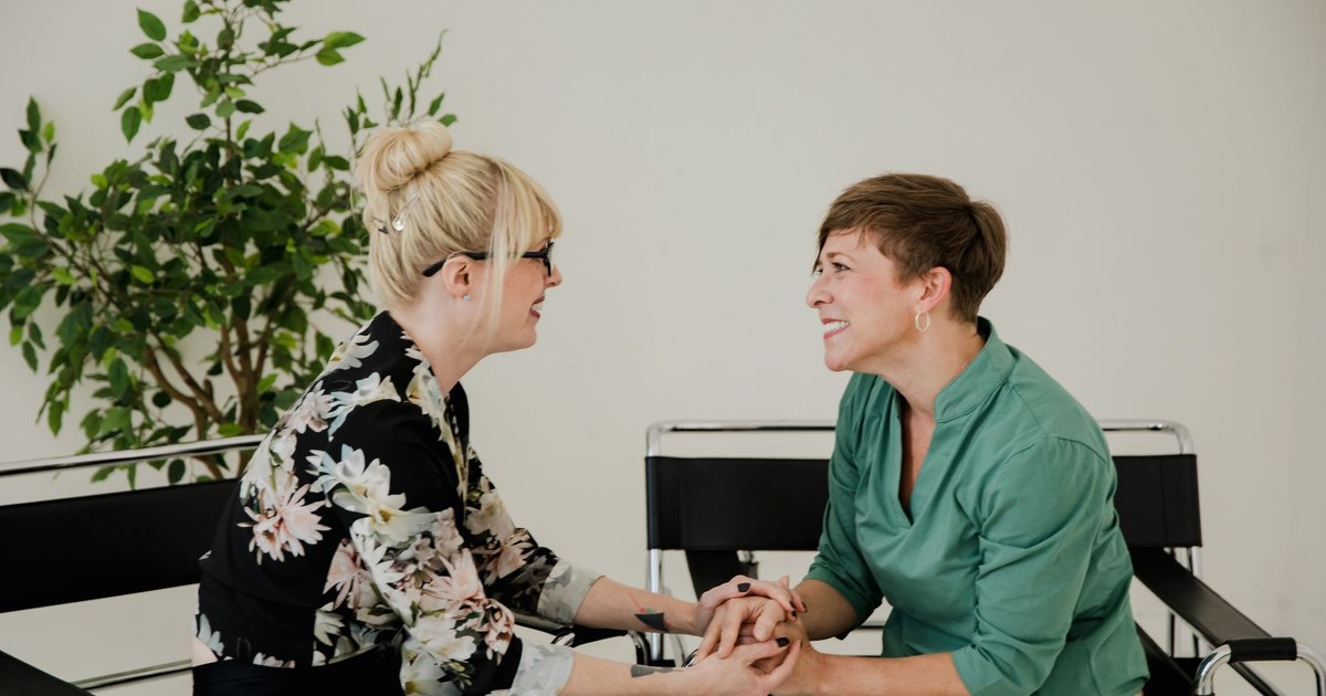 Two people having a warm, supportive conversation