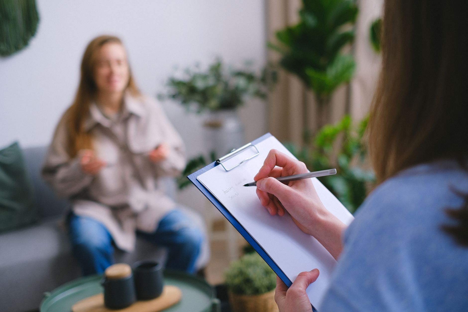 Therapist taking supportive notes during a session