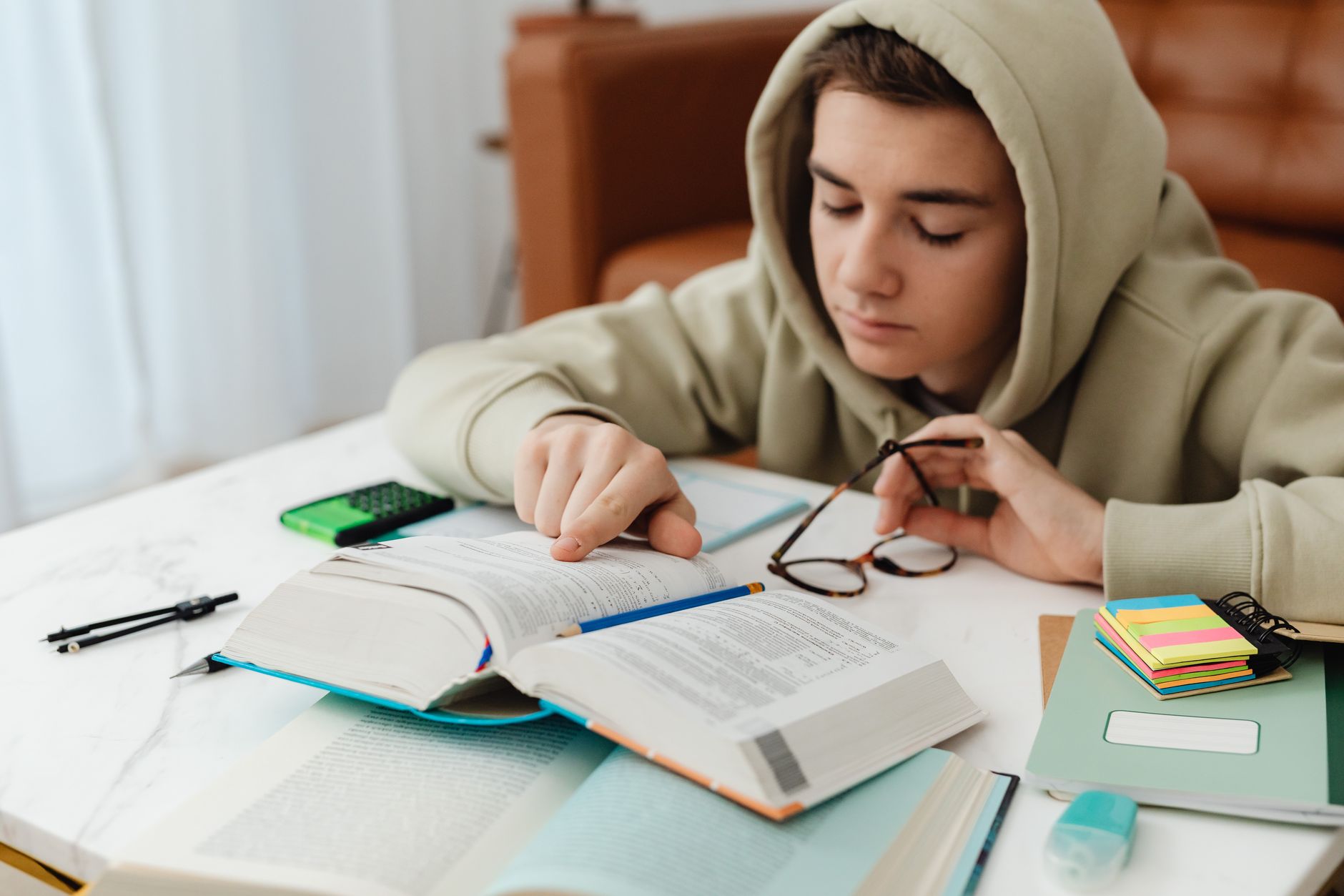 Teenager focused on studying at a desk
