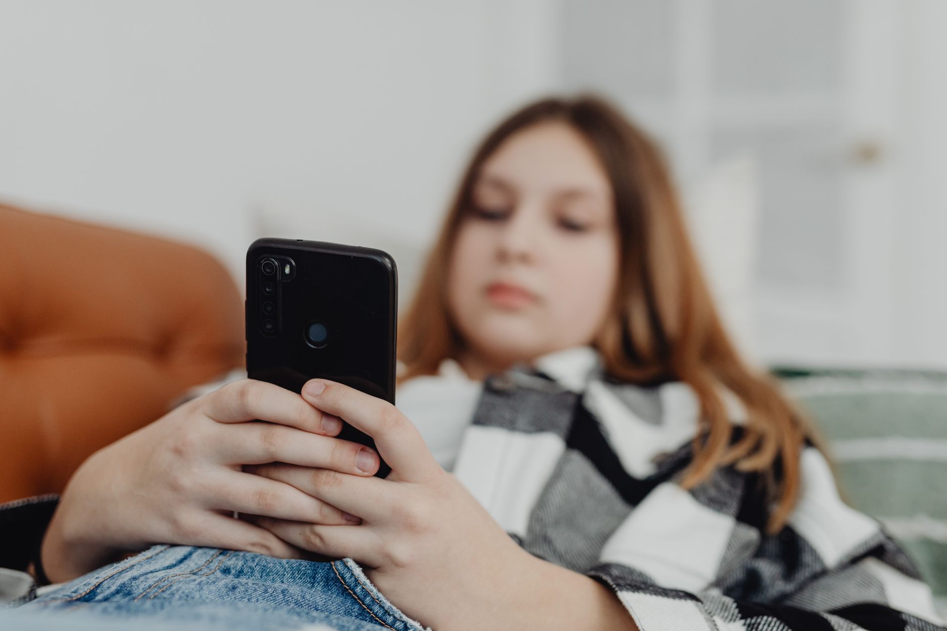Teen stressed while on their phone