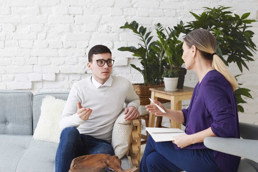 Therapist and client having a conversation in a counselling office