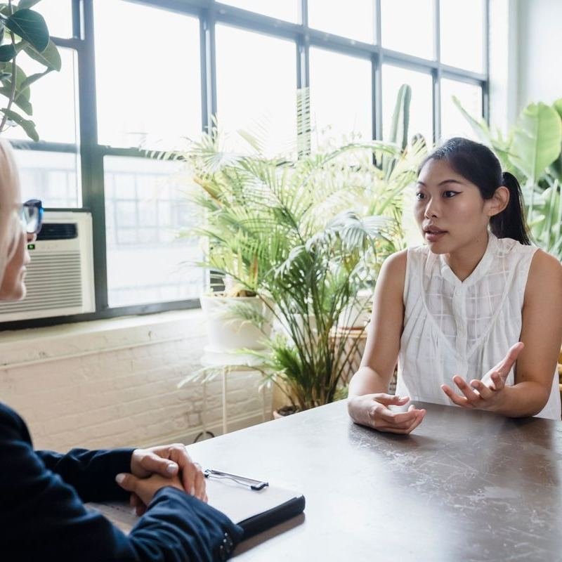 Therapist and client in conversation during a counselling session in Milton