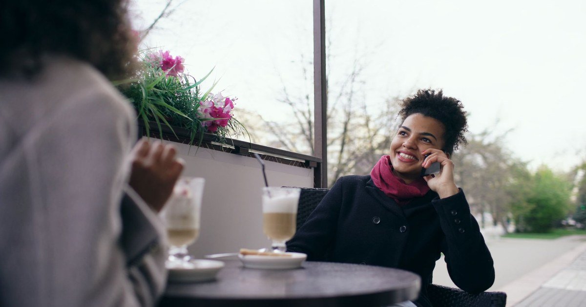 A woman enjoying a quiet, unhurried moment with coffee at an outdoor cafe
