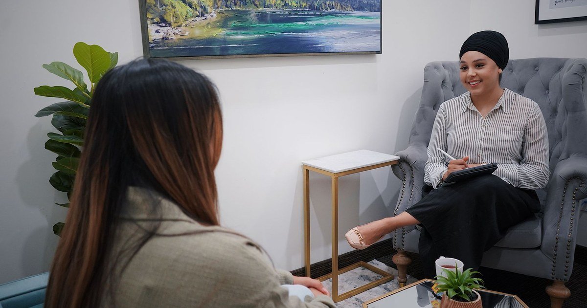 Two women having a calm, supportive conversation in a bright office